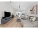 Spacious living room with wood-look floors, vaulted ceilings, neutral paint, and open concept design at 12229 Coldstream Ln, Tampa, FL 33626