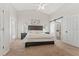 Cozy primary bedroom with plush carpet, a ceiling fan, and an ensuite bathroom with a sliding barn door at 12229 Coldstream Ln, Tampa, FL 33626