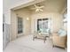 Relaxing covered patio with ceiling fan, stylish seating, and sliding door access to the indoors at 12229 Coldstream Ln, Tampa, FL 33626