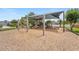 Community playground with swings and multiple play structures set on a wood chip base, providing a safe play area at 12229 Coldstream Ln, Tampa, FL 33626