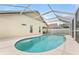 Sparkling in-ground pool with screened enclosure, providing a private oasis for relaxation and recreation at 12229 Coldstream Ln, Tampa, FL 33626