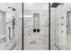 Walk-in shower featuring black hardware, decorative tile, and a shower niche for storage at 12229 Coldstream Ln, Tampa, FL 33626