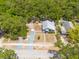 Property boasts a home with driveway, fenced yard, and the surrounding lush landscape at 1235 Bass Blvd, Dunedin, FL 34698
