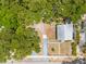 An aerial view shows the home, driveway, fenced yard and the surrounding landscape at 1235 Bass Blvd, Dunedin, FL 34698