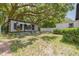 Cozy home featuring an expansive backyard shaded by a mature oak tree at 1235 Bass Blvd, Dunedin, FL 34698