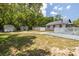 Large backyard with storage sheds and garage space behind a white picket fence at 1235 Bass Blvd, Dunedin, FL 34698