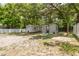 View of the backyard including a white fence, shed, and second building at 1235 Bass Blvd, Dunedin, FL 34698