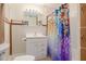 Cozy bathroom featuring a vanity with drawers, mirror, and a shower with a colorful curtain at 1235 Bass Blvd, Dunedin, FL 34698