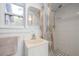 Well-lit bathroom features a single vanity, tiled shower, and a window for natural light at 1235 Bass Blvd, Dunedin, FL 34698