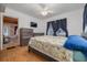 Comfortable bedroom with natural wood floors, two windows, and neutral decor at 1235 Bass Blvd, Dunedin, FL 34698