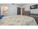 Comfortable bedroom with furniture, neutral decor, and access to a full bathroom at 1235 Bass Blvd, Dunedin, FL 34698