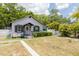 Charming cottage-style home with a well-manicured lawn and a classic white picket fence at 1235 Bass Blvd, Dunedin, FL 34698