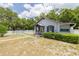 Cottage-style home with a tidy front yard, complemented by a charming picket fence at 1235 Bass Blvd, Dunedin, FL 34698