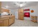 Bright kitchen featuring natural wood cabinets, tile flooring, and ample counter space at 1235 Bass Blvd, Dunedin, FL 34698