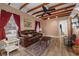 Cozy living room with beamed ceiling, wood floors, and comfortable seating at 1235 Bass Blvd, Dunedin, FL 34698
