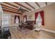 Inviting living room with exposed wood beams, wood flooring, and plentiful light at 1235 Bass Blvd, Dunedin, FL 34698