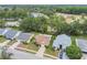Scenic aerial view of a neighborhood with well-spaced homes, mature trees, and a tranquil pond, creating a peaceful community at 13127 Topflite Ct, Hudson, FL 34669