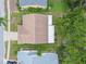 Overhead view of home featuring a large roof and covered patio surrounded by mature trees and well-maintained landscaping at 13127 Topflite Ct, Hudson, FL 34669