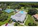 An aerial view of community amenities including the pool, tennis court, golf course, and clubhouse at 13127 Topflite Ct, Hudson, FL 34669