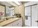 Bathroom has a single sink vanity, large mirror and a glass shower at 13127 Topflite Ct, Hudson, FL 34669