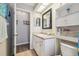 Bright bathroom featuring a vanity with storage and neutral tiling at 13127 Topflite Ct, Hudson, FL 34669
