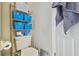 This bathroom includes a toilet, storage shelving, and towel rack at 13127 Topflite Ct, Hudson, FL 34669