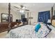 Bedroom boasts a large bed, ceiling fan, bassinet, and decor at 13127 Topflite Ct, Hudson, FL 34669