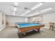 Relaxing billiard room features two pool tables, ample lighting, and cozy seating at 13127 Topflite Ct, Hudson, FL 34669