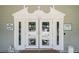 Clubhouse entrance featuring double doors with Welcome to Meadow Oaks logo and operating hours sign at 13127 Topflite Ct, Hudson, FL 34669