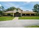 Exterior front view of the Meadow Oaks Golf & Country Club with stone accents at 13127 Topflite Ct, Hudson, FL 34669