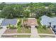 Charming single-story home with a well-manicured front yard and a long driveway, complemented by mature landscaping and a palm tree at 13127 Topflite Ct, Hudson, FL 34669