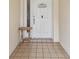 Charming front door with decorative accents and a small table, welcoming guests to the home at 13127 Topflite Ct, Hudson, FL 34669