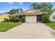 Well-maintained single-story home with large driveway and tidy front landscaping at 13127 Topflite Ct, Hudson, FL 34669