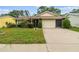 Inviting single-story home features a well-kept lawn and a two-car garage at 13127 Topflite Ct, Hudson, FL 34669