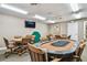 Clubhouse game room with comfortable seating, poker table and a wall mounted television at 13127 Topflite Ct, Hudson, FL 34669