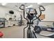 Community gym equipped with an elliptical, treadmill, multi-station machine, and a mirror at 13127 Topflite Ct, Hudson, FL 34669