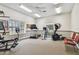 Community gym with exercise machines, weights, ceiling fan, and natural light at 13127 Topflite Ct, Hudson, FL 34669