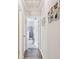 Hallway with wood floors, art, and access to rooms at 13127 Topflite Ct, Hudson, FL 34669
