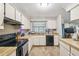 Well-lit kitchen features laminate countertops and floors at 13127 Topflite Ct, Hudson, FL 34669