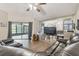 Spacious living room features sliding glass doors and hardwood flooring at 13127 Topflite Ct, Hudson, FL 34669
