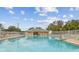 Outdoor community pool featuring crystal-clear water, deck chairs for relaxation, and well-maintained surrounding landscape at 13127 Topflite Ct, Hudson, FL 34669