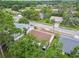 A serene street showcases well-maintained homes surrounded by lush greenery and mature trees at 13127 Topflite Ct, Hudson, FL 34669