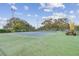Community tennis courts with green surfaces, tall trees, and blue skies create an active and engaging environment at 13127 Topflite Ct, Hudson, FL 34669