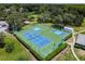 Overhead shot of community tennis and pickleball courts offers an active and social lifestyle for residents at 13127 Topflite Ct, Hudson, FL 34669