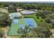 Aerial view showcasing tennis and pickleball courts, perfect for an active lifestyle in a lush community at 13127 Topflite Ct, Hudson, FL 34669