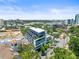 Aerial view of a modern building complex with a rooftop terrace, nestled among lush greenery in the city at 132 Mirror Lake N Dr # 501, St Petersburg, FL 33701