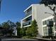 Modern building with glass windows and clean architectural lines surrounded by trees at 132 Mirror Lake N Dr # 501, St Petersburg, FL 33701