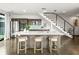 Modern kitchen with an island, barstool seating, wood floors, and stainless steel appliances at 132 Mirror Lake N Dr # 501, St Petersburg, FL 33701
