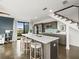 Modern kitchen with an island, barstool seating, wood floors, and stainless steel appliances at 132 Mirror Lake N Dr # 501, St Petersburg, FL 33701
