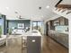 Modern kitchen with island and stainless steel appliances, seamlessly connected to the open-concept living area at 132 Mirror Lake N Dr # 501, St Petersburg, FL 33701